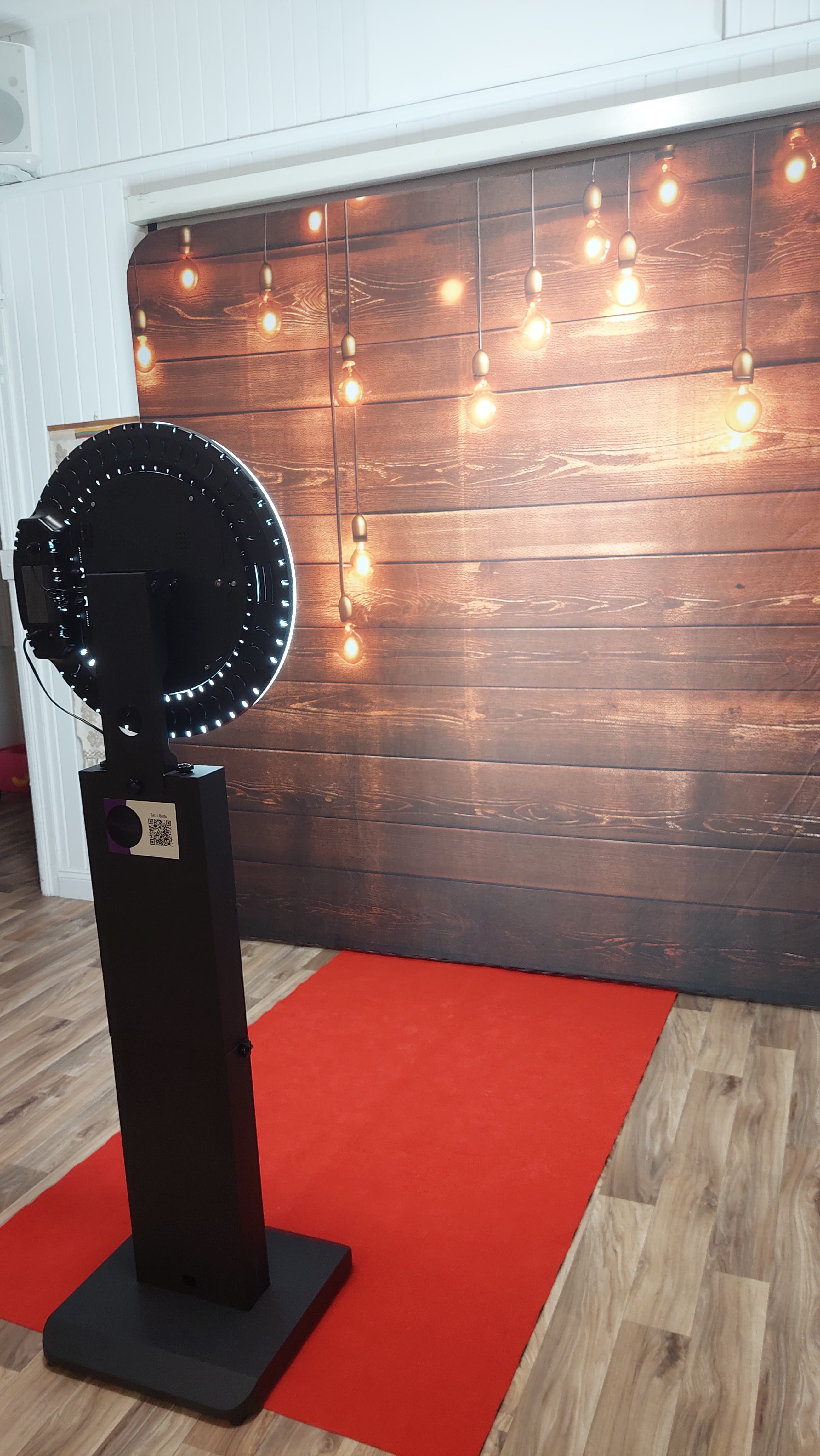 Backdrop featuring wood with lights and photobooth in foreground